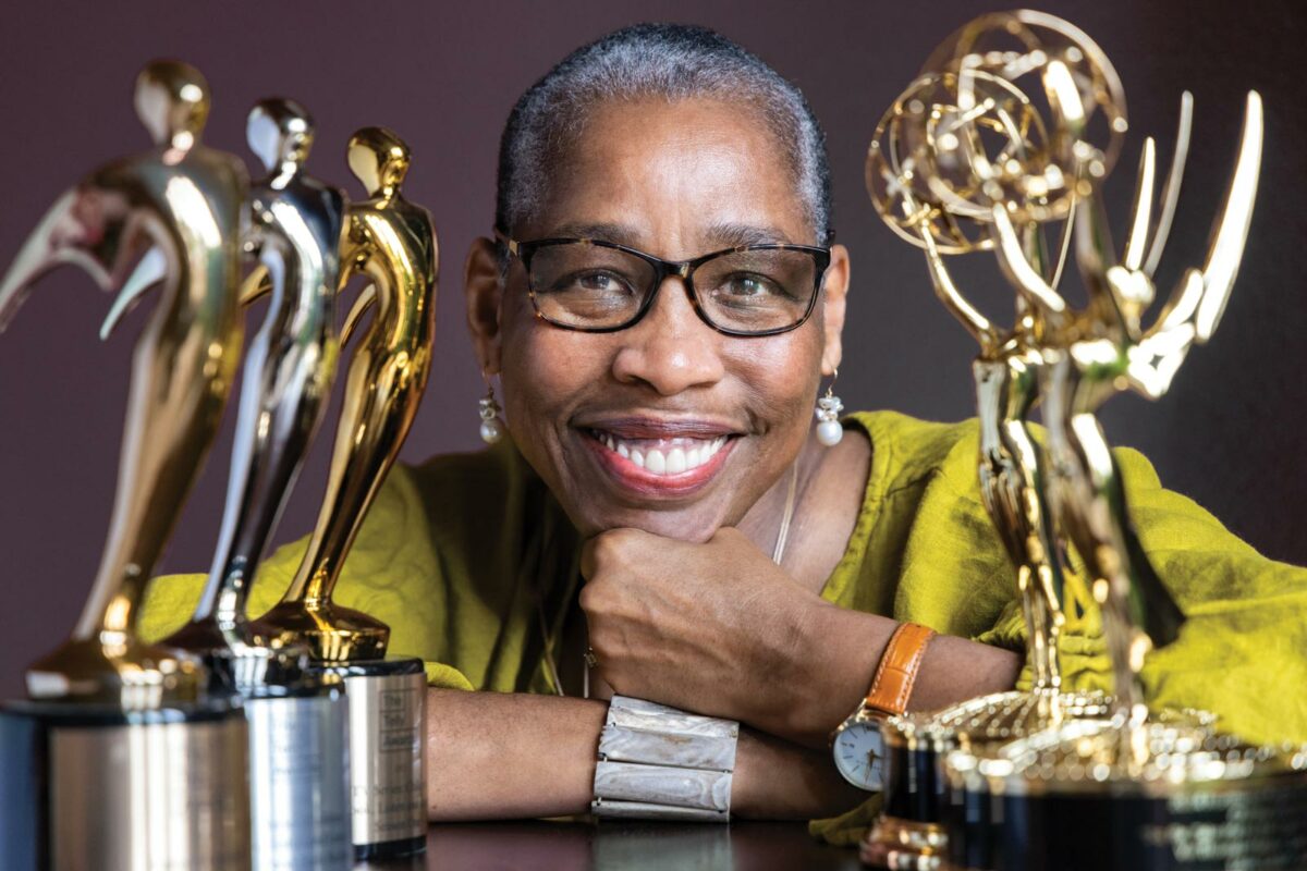 Val Thomas-Matson, producer and star of “Look, Listen and Learn,” smiling while holding Emmy and Telly Awards.