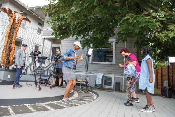 Behind the scenes of “Look, Listen and Learn,” Val Thomas-Matson laughs and plays with children on set.
