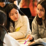 Students and parents exploring media literacy resources at MisinfoDay event