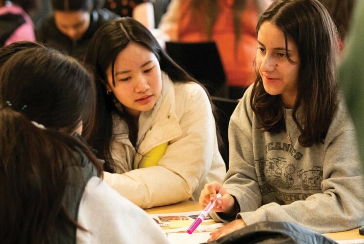 Students and parents exploring media literacy resources at MisinfoDay event