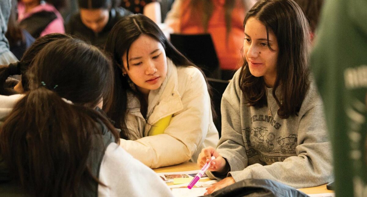 Students and parents exploring media literacy resources at MisinfoDay event