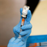 Pharmacist prepares a COVID-19 vaccine dose at a Washington clinic