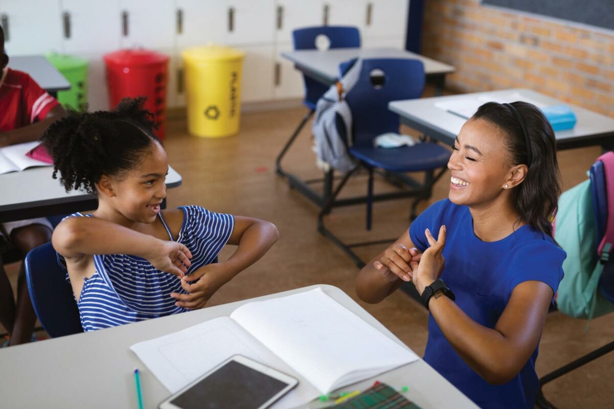 An ASL interpreter communicates with a student in a Seattle Public Schools classroom. Advocates say consistent, qualified interpreting is essential for DHH students to thrive.