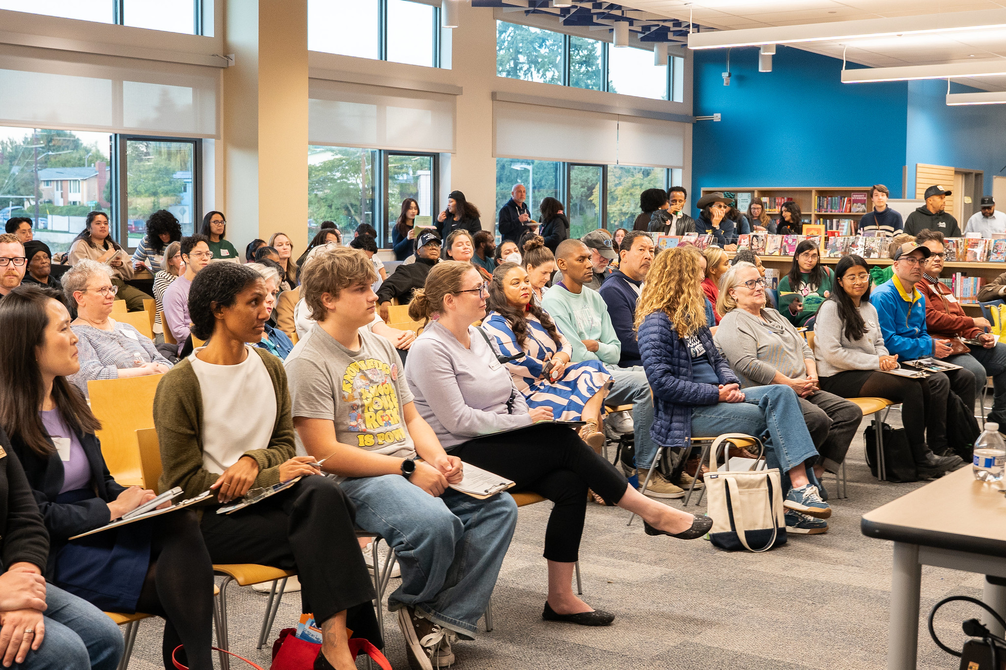 Families, students, and candidates engage in discussion during the Seattle Education Forum at Rainier Beach High School, focused on education equity, housing, and school safety.