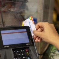 Washington shopper checking out at grocery store; many families rely on SNAP and state food assistance benefits.