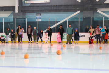 Pumpkin curling at Kraken Community Iceplex, where families enjoy a fun and kid-friendly Halloween activity on the ice.