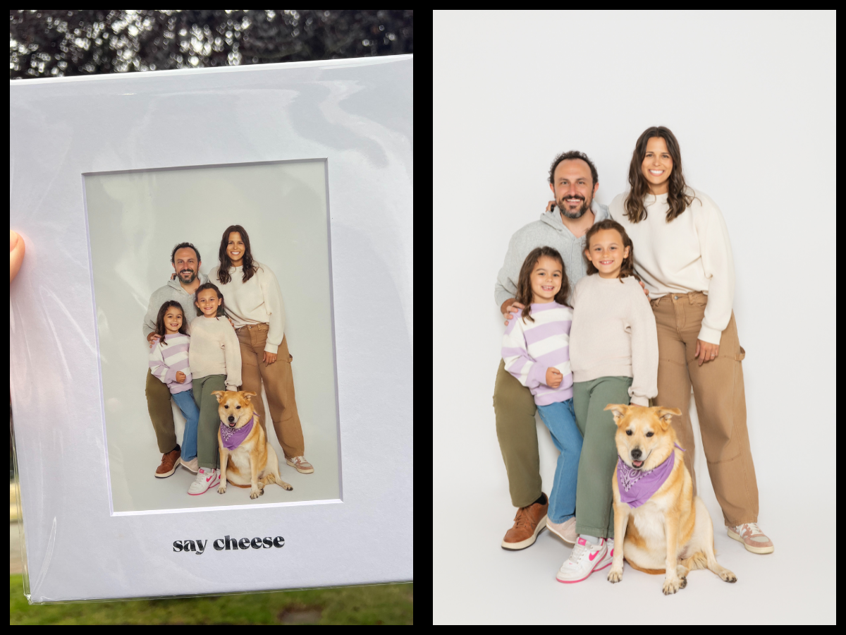 A family of four and their dog posing together in a printed portrait from Seattle’s Say CHEESE selfie studio, held up outdoors in its white photo mat.