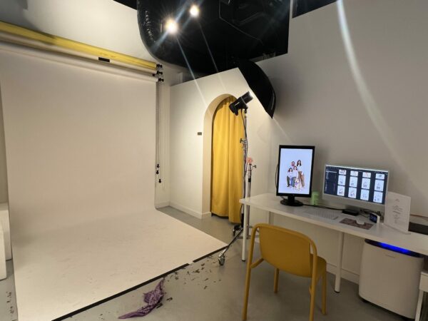 Interior of the Say CHEESE selfie studio in Seattle, showing the backdrop, camera setup, studio lighting, timer, and monitor for reviewing photos.