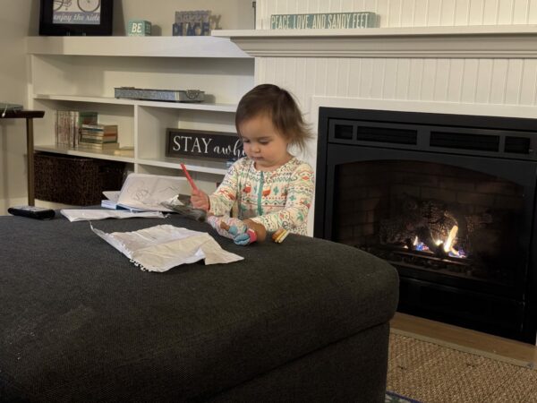 Toddler drawing in front of the fire in Seabrook, WA