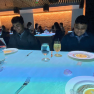 Children watching animated Le Petit Chef projections on their plates during an immersive dining experience in Seattle
