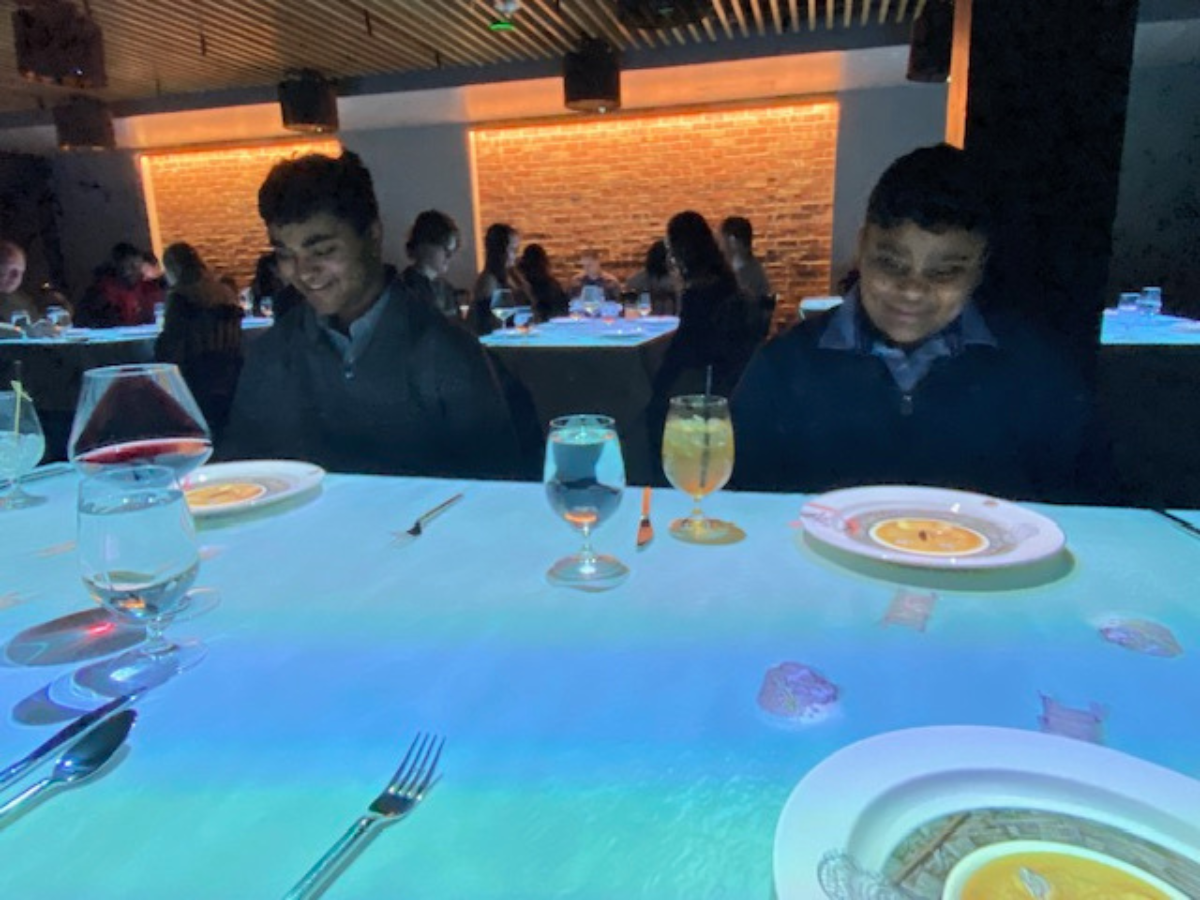 Children watching animated Le Petit Chef projections on their plates during an immersive dining experience in Seattle